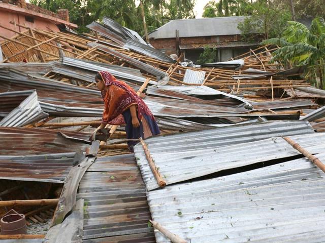 In-this-photograph-taken-on-April-5-2015-a-Bangladeshi-victim-gathers-her-belongings-near-her-home-which-was-destroyed-during-storms-in-Bogra-some-200km-from-Dhaka-AFP-Photo In-this-photograph-taken-on-April-5-2015-a-Bangladeshi-victim-gathers-her-belongings-near-her-home-which-was-destroyed-during-storms-in-Bogra-some-200km-from-Dhaka-AFP-Photo