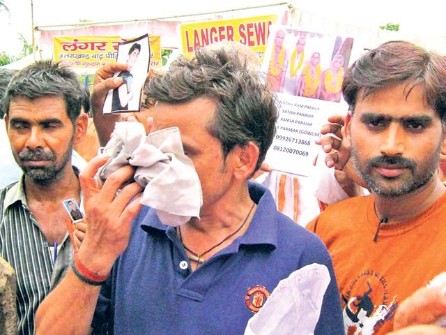 People-hold-pictures-of-their-relatives-who-went-missing-after-the-June-2013-disaster-in-Dehradun-HT-file-photo People-hold-pictures-of-their-relatives-who-went-missing-after-the-June-2013-disaster-in-Dehradun-HT-file-photo
