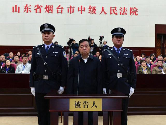 Former-Nanjing-mayor-Ji-Jianye-C-standing-on-trial-in-a-court-room-of-Yantai-Intermediate-People-s-Court-in-Yantai-AFP-Photo