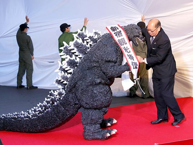 Godzilla gets a sash of "Shinjuku-ward tourism ambassador" from the Kabuki-cho Shopping Area Promotion Association Chief Director Mototsugu Katagiri of Tokyo's Shinjuku-ward during its awards ceremony in Tokyo. AP/Shizuo Kambayashi Godzilla gets a sash of "Shinjuku-ward tourism ambassador" from the Kabuki-cho Shopping Area Promotion Association Chief Director Mototsugu Katagiri of Tokyo's Shinjuku-ward during its awards ceremony in Tokyo. AP/Shizuo Kambayashi