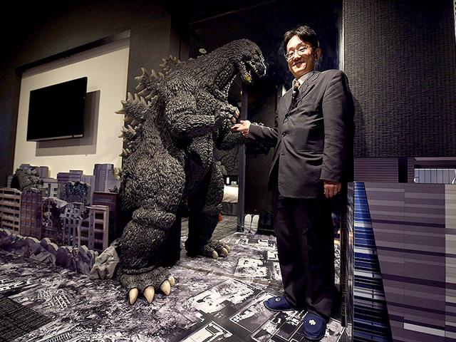 A hotel clerk introduces a Godzilla statue at "Godzilla Room" of Hotel Gracery Shinjuku at Kabukicho shopping district in Tokyo. AFP/Toru Yamanaka A hotel clerk introduces a Godzilla statue at "Godzilla Room" of Hotel Gracery Shinjuku at Kabukicho shopping district in Tokyo. AFP/Toru Yamanaka