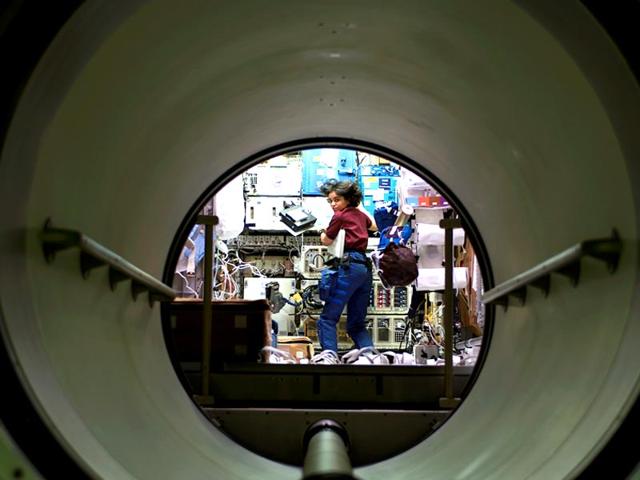 Human space flight day | Taken on January 18, 2002 | The tunnel linking the SPACEHAB Research Double Module to the Space Shuttle Columbia's crew cabin provides an interesting point of view in this scene of astronaut Kalpana Chawla, mission specialist, performing work in SPACEHAB. PHOTO: NASA