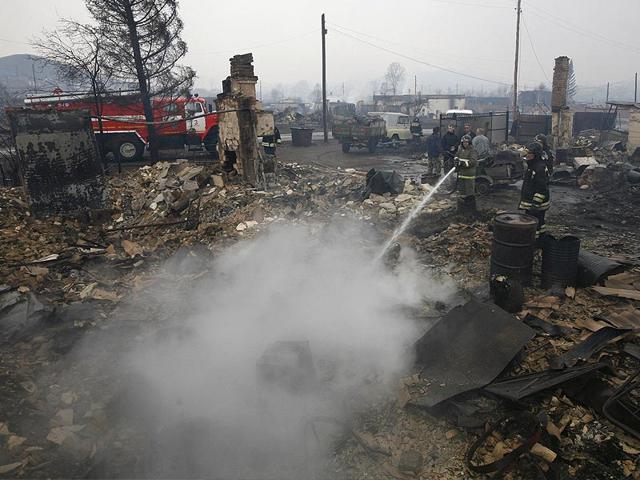 Firefighters-work-amidst-the-debris-of-a-burnt-building-in-the-settlement-of-Shyra-damaged-by-recent-wildfires-in-Khakassia-region-Photo-Reuters