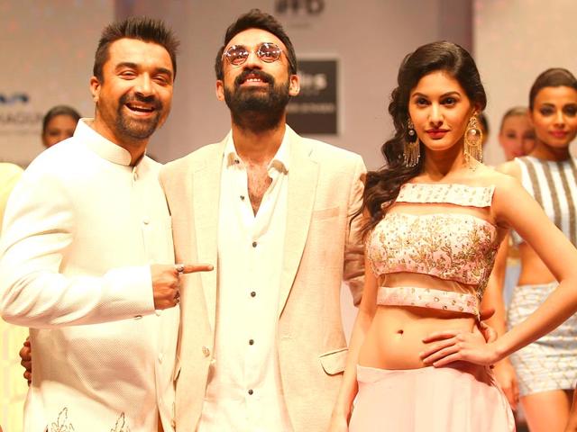 Actor Ajaz Khan and actresss Amyra Dastur walk on the ramp at India Runway Week show, in New Delhi, on April 12, 2014. (Photo: IANS)