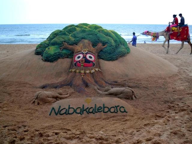 Puri beach, India: A camel carrying tourist walks near Indian sand artist Sudarsan Pattnaik's sand sculpture on Nabakalebara at Golden Sea Beach Puri, some 65 km from Bhubaneswar on April 8. The term Nabakalebara is an ancient ritual associated with most of the Jagannath Temples when the idols of Lord Jagannath, Balabhadra, Subhadra and Sudarshan are replaced by a new set of idols. A year of Ashadha of the Hindu calendar is auspicious for conducting the ceremony and this usually occurs every twelve to nineteen years. The deities are made from a special type of Neem wood known as Daru Bramha and preparations for the ceremony start in the month of Chaitra. (Photos: AFP)