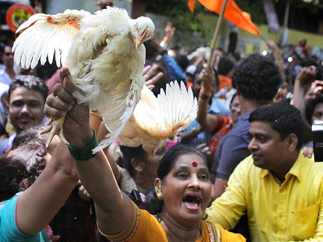 Shiv Sena workers celebrated Congress leader Narayan Rane's defeat in Bandra (East) bypoll outside his residence by bursting crackers, waving saffron flags and shouting party slogans. (Kalpak Pathak/HT photo)