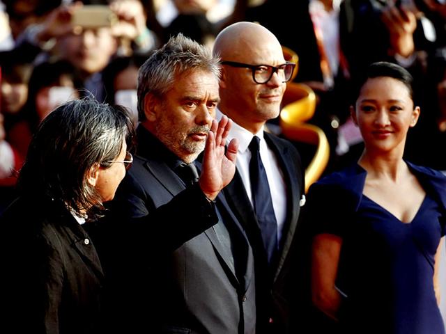 French director Luc Besson (second from left) waves as he walks the red carpet with Russian director Fyodor Bondarchuk (second from right) and Chinese actor Zhou Xun (R) during the Beijing International Film Festival in Beijing, April 16, 2015. (Reuters) French director Luc Besson (second from left) waves as he walks the red carpet with Russian director Fyodor Bondarchuk (second from right) and Chinese actor Zhou Xun (R) during the Beijing International Film Festival in Beijing, April 16, 2015. (Reuters)