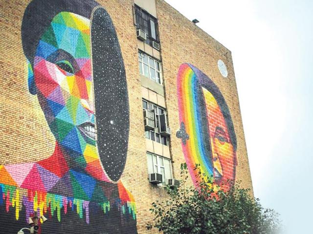Okuda, Spain: Composed of multi-coloured geometric prints, this piece can be found on the walls of the Lok Nayak Bhawan building in the heart of Khan Market. Okuda's art often raises contradictions about existentialism, the universe and the infinite, the meaning of life, and the false freedom of capitalism. This explosive piece calls into question the notion of Khan Market being a hangout place for only those with big bucks. Okuda, Spain: Composed of multi-coloured geometric prints, this piece can be found on the walls of the Lok Nayak Bhawan building in the heart of Khan Market. Okuda's art often raises contradictions about existentialism, the universe and the infinite, the meaning of life, and the false freedom of capitalism. This explosive piece calls into question the notion of Khan Market being a hangout place for only those with big bucks.