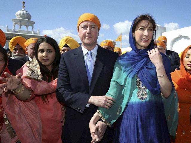 Britain's Prime Minister David Cameron and his wife Samantha take part the Vaisakhi Nagar Kirtan procession at Guru Nanak Darbar Gurdwara temple on Saturday, April 18, 2015, in Gravesend, England.AP Britain's Prime Minister David Cameron and his wife Samantha take part the Vaisakhi Nagar Kirtan procession at Guru Nanak Darbar Gurdwara temple on Saturday, April 18, 2015, in Gravesend, England.AP