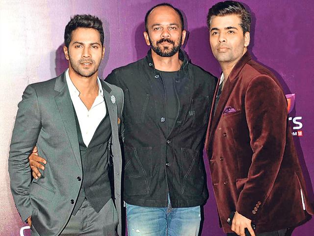 Varun Dhawan, Rohit Shetty and Karan Johar pose for shutterbugs at an event in Mumbai.