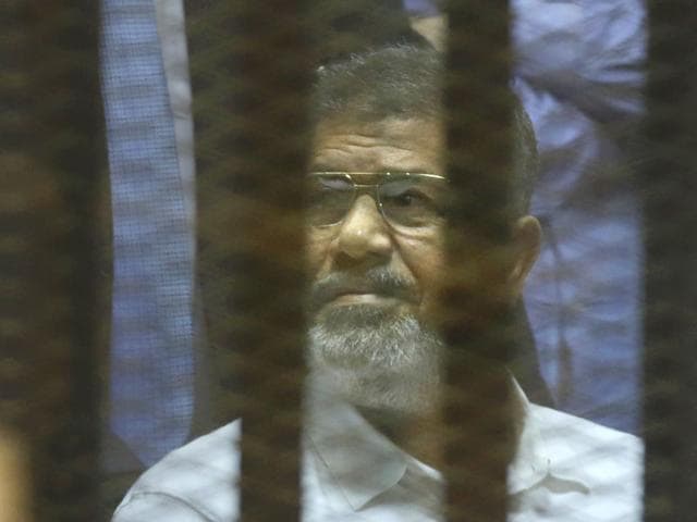Egypt-s-ousted-Islamist-President-Mohammed-Morsi-sits-in-a-soundproof-glass-cage-inside-a-makeshift-courtroom-at-Egypt-s-national-police-academy-in-Cairo-Egypt-AP-Photo Egypt-s-ousted-Islamist-President-Mohammed-Morsi-sits-in-a-soundproof-glass-cage-inside-a-makeshift-courtroom-at-Egypt-s-national-police-academy-in-Cairo-Egypt-AP-Photo