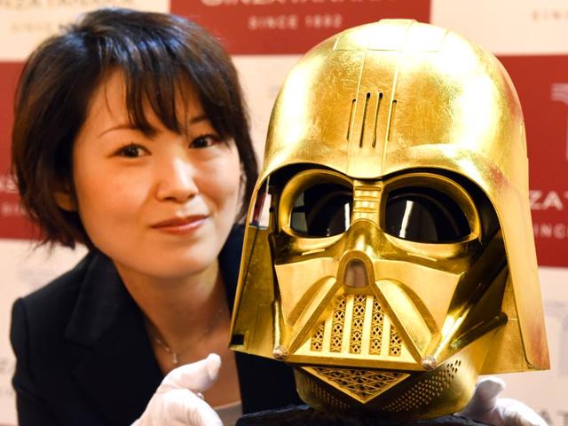A-sales-clerk-introduces-a-Darth-Vader-mask-gilded-with-gold-leaf-produced-by-Japan-s-jeweler-Ginza-Tanaka-in-Tokyo-on-April-22-2015-AFP-PHOTO A-sales-clerk-introduces-a-Darth-Vader-mask-gilded-with-gold-leaf-produced-by-Japan-s-jeweler-Ginza-Tanaka-in-Tokyo-on-April-22-2015-AFP-PHOTO