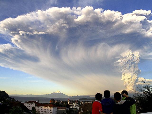 Children watch the Calbuco volcano erupt, from Puerto Varas, Chile. AP