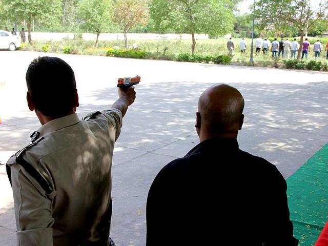 Inspector-general-Hisar-range-Anil-Kumar-training-a-pellet-gun-on-his-subordinates-for-a-demonstration-in-Hisar-on-Wednesday-HT-Photo