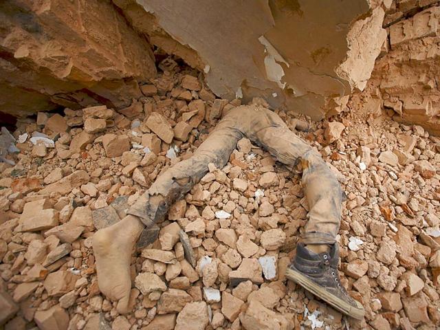 A body of a victim lies trapped in the debris after an earthquake hit, in Kathmandu, Nepal on Saturday. (Reuters Photo)