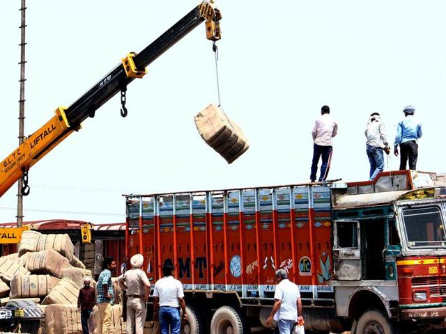 Labour refusing to unload truck of gunny bags, the authorities arranged crane to the service in Patiala. Bharat Bhushan/HT
