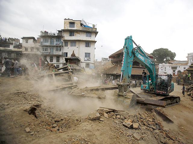 A-crane-removes-debris-from-the-site-of-a-building-that-collapsed-in-an-earthquake-in-Kathmandu-Nepal-AP-Photo A-crane-removes-debris-from-the-site-of-a-building-that-collapsed-in-an-earthquake-in-Kathmandu-Nepal-AP-Photo