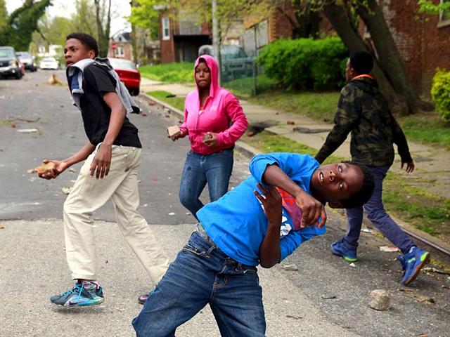 Demonstrators-throw-rocks-at-Baltimore-police-during-clashes-in-Baltimore-Reuters Demonstrators-throw-rocks-at-Baltimore-police-during-clashes-in-Baltimore-Reuters