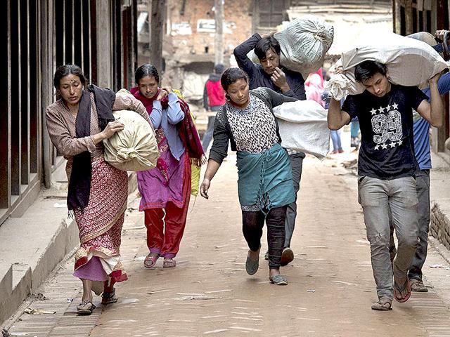 An-airport-officer-writes-queue-numbers-on-Indians-hands-as-they-queue-up-for-an-aircraft-to-evacuate-to-their-country-at-Nepal-s-Tribhuvan-International-Airport-Reuters An-airport-officer-writes-queue-numbers-on-Indians-hands-as-they-queue-up-for-an-aircraft-to-evacuate-to-their-country-at-Nepal-s-Tribhuvan-International-Airport-Reuters
