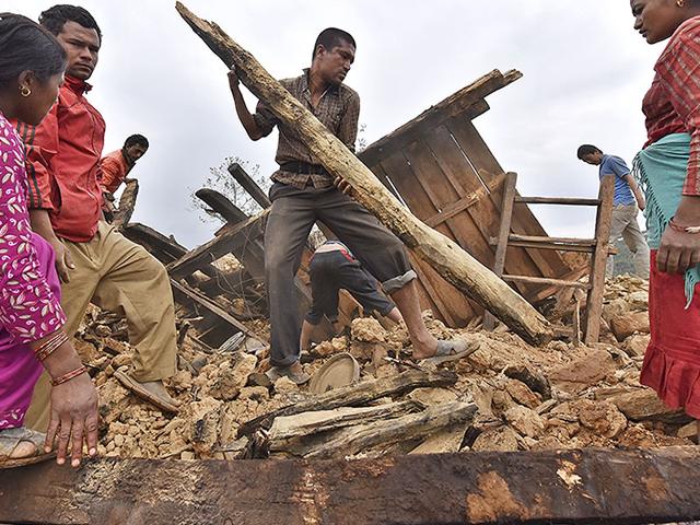 A-man-clears-the-debris-of-his-damaged-house-with-the-help-of-his-family-members-in-Sindhupalchok-district-in-Nepal-Gurinder-Osan-HT-Photo A-man-clears-the-debris-of-his-damaged-house-with-the-help-of-his-family-members-in-Sindhupalchok-district-in-Nepal-Gurinder-Osan-HT-Photo