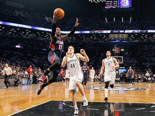 Dennis-Schroder-of-the-Atlanta-Hawks-goes-to-the-hoop-in-the-first-half-against-Bojan-Bogdanovic-of-the-Brooklyn-Nets-during-game-six-in-the-first-round-of-the-2015-NBA-Playoffs-at-Barclays-Center-in-the-Brooklyn-borough-of-New-York-City-AFP-PHOTO Dennis-Schroder-of-the-Atlanta-Hawks-goes-to-the-hoop-in-the-first-half-against-Bojan-Bogdanovic-of-the-Brooklyn-Nets-during-game-six-in-the-first-round-of-the-2015-NBA-Playoffs-at-Barclays-Center-in-the-Brooklyn-borough-of-New-York-City-AFP-PHOTO