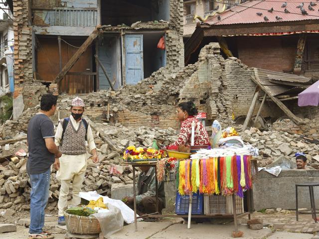 A-woman-sells-temple-paraphenalia-outside-a-damaged-building-near-Pashupatinath-temple-in-Kathmandu-Gurinder-Osan-HT-Photo A-woman-sells-temple-paraphenalia-outside-a-damaged-building-near-Pashupatinath-temple-in-Kathmandu-Gurinder-Osan-HT-Photo