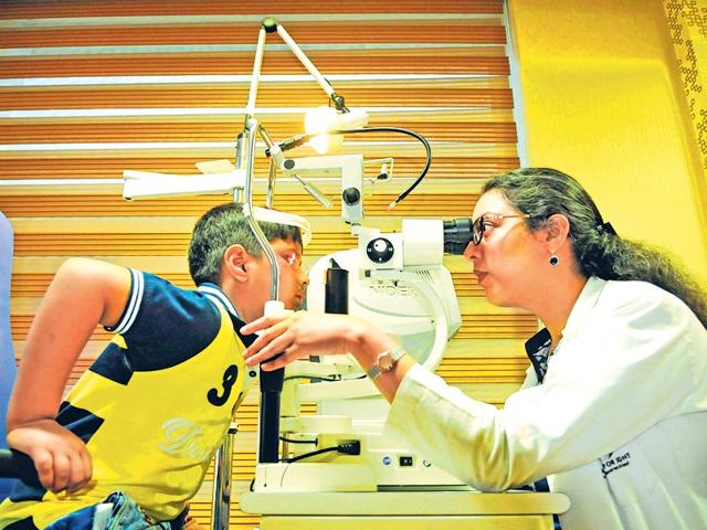 Dr-Ritika-Sachdev-tests-a-child-s-eyes-on-a-slit-lamp-at-the-Centre-of-Sight-an-eye-clinic-in-Delhi-In-India-myopia-affects-about-one-in-three-people-and-one-in-eight-12-year-olds-Saumya-Khandelwal-HT