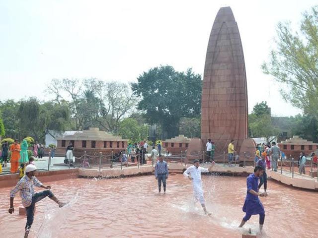 Tourist playing with water at Jallianwala Bagh.HT