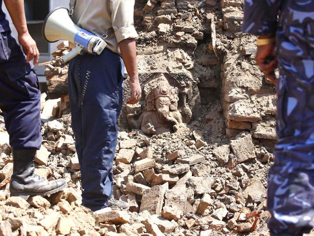 An idol of Lord Ganesha lies buried in debris, as Nepal Army personnel and volunteers carry out rescue ops in Kathmandu after the 7.9-magnitude quake. (Raj K Raj/ HT Photo)