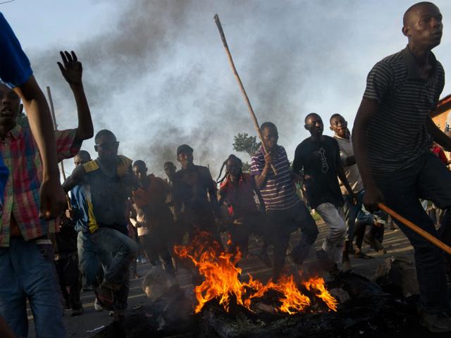 Protestors-run-across-a-fire-towards-police-lines-in-the-Musaga-neighbourhood-of-Bujumbura-AFP-Photo Protestors-run-across-a-fire-towards-police-lines-in-the-Musaga-neighbourhood-of-Bujumbura-AFP-Photo