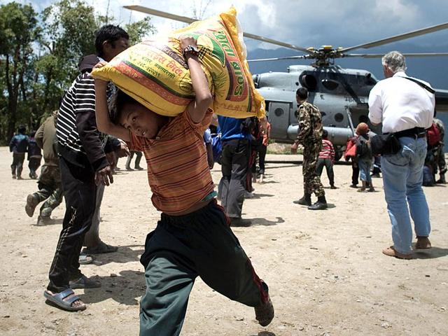 A-Nepalese-boy-carrying-a-bag-of-rice-out-of-an-IAF-helicopter-bringing-relief-food-to-the-village-of-Barpak-nine-days-after-a-devastating-earthquake-struck-the-Himalayan-nation-on-April-25-AFP-Photo A-Nepalese-boy-carrying-a-bag-of-rice-out-of-an-IAF-helicopter-bringing-relief-food-to-the-village-of-Barpak-nine-days-after-a-devastating-earthquake-struck-the-Himalayan-nation-on-April-25-AFP-Photo