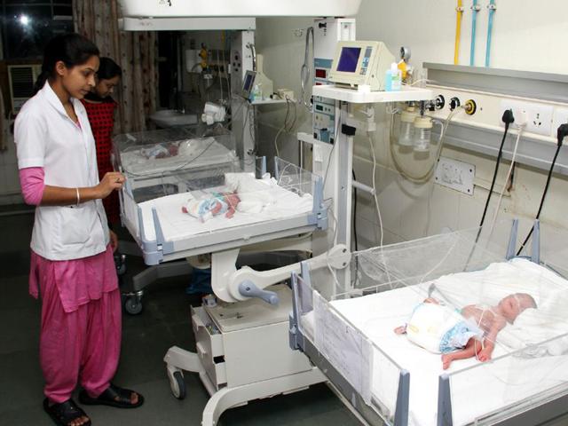 A--staff-nurse-taking-care-of-the-newborns--who-are-presently-kept-in-incubators--at-Adesh-Hospital--in-Bathinda-on-Tuesday-Sanjeev-Kumar-HT