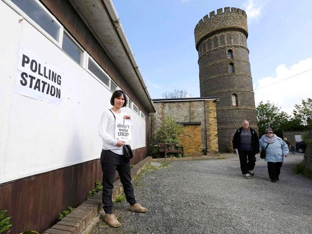 Voter Rachel Bell holds a sign that says "I didn't vote UKIP" after voting at a polling station in Broadstairs, southeast Britain. (Reuters)