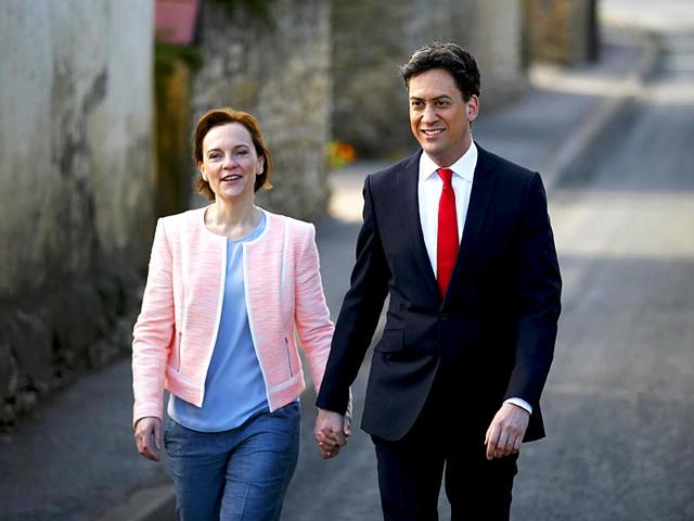 Britain's opposition Labour Party leader Ed Miliband arrives to vote with his wife Justine in Doncaster, northern England. (Reuters)