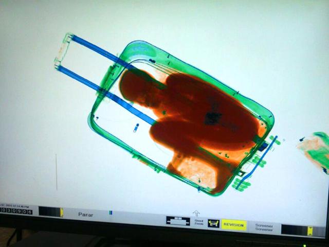 In-this-photo-released-by-the-Spanish-Guardia-Civil-a-boy-curled-up-inside-a-suitcase-is-seen-on-the-display-of-a-scanner-at-the-border-crossing-in-Ceuta-a-Spanish-city-enclave-in-North-Africa-AP-Photo-Spanish-interior-ministry In-this-photo-released-by-the-Spanish-Guardia-Civil-a-boy-curled-up-inside-a-suitcase-is-seen-on-the-display-of-a-scanner-at-the-border-crossing-in-Ceuta-a-Spanish-city-enclave-in-North-Africa-AP-Photo-Spanish-interior-ministry