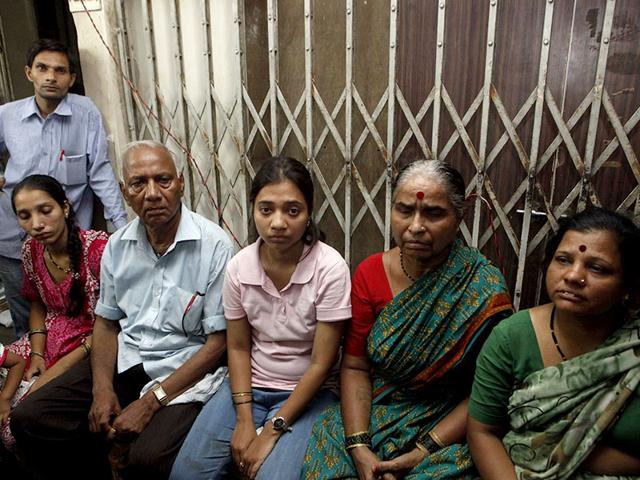 The residents of Gokul Niwas building in Kalbadevi, which caught fire, wait as the fire brigade officials try to douse the blaze. (Pratham Gokhale/HT photo)