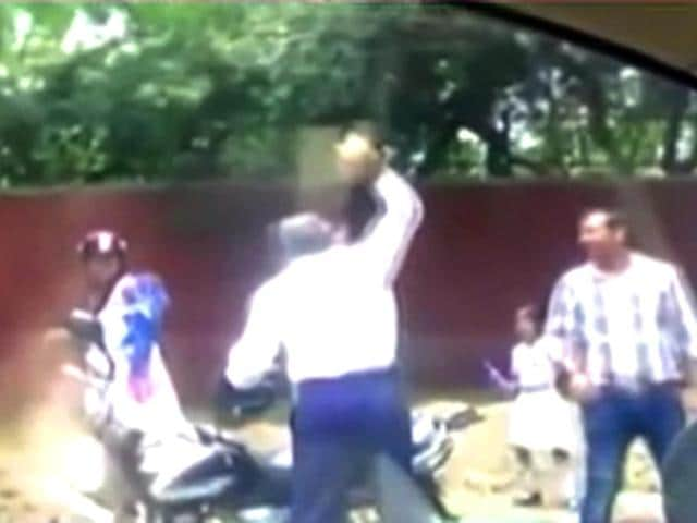 A-Delhi-Police-constable-was-caught-on-camera-hurling-a-stone-at-a-woman-Photo-Aaj-Tak-s-YouTube-channel