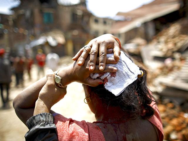 A woman injured in an earthquake walks toward a hospital soon after the earthquake in Sankhu, Nepal. (Reuters)