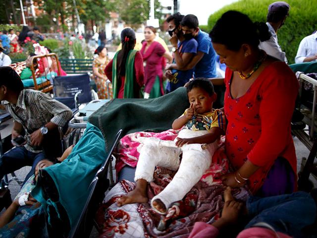 Earthquake victims are kept on the open ground for treatment after the earthquake in Kathmandu. (Reuters Photo)