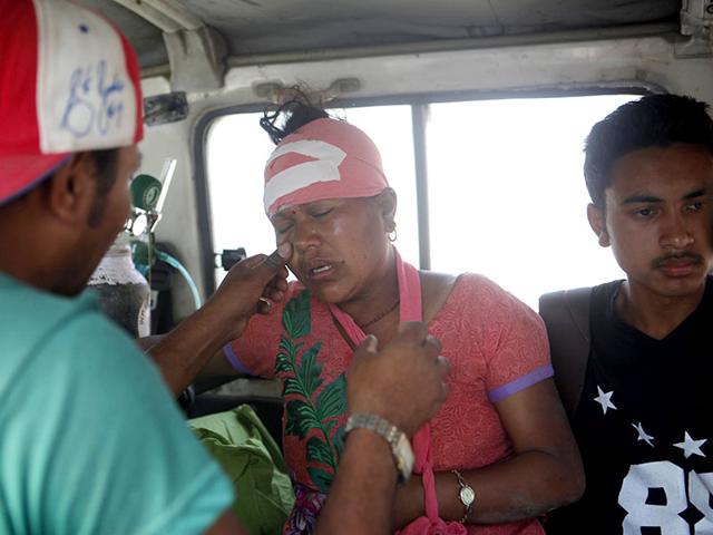 An injured Nepalese woman cries as she is taken to a hospital in Kathmandu. (AP Photo)