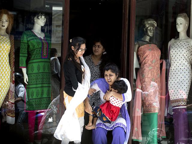 Local residents evacuate a shop during the earthquake in central Kathmandu. (Reuters Photo)