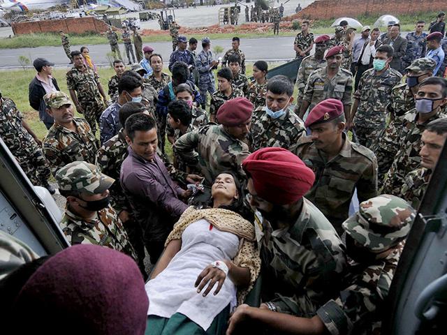Earthquake victims being received at Kathmandu airport by Nepali army and Indian Air Force. (Burhaan Kinu/ HT Photo)