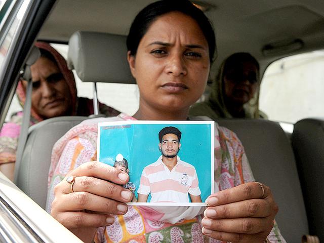 Gurpinder-Kaur-showing-a-photo-of-her-missing-brother-HT-Photo Gurpinder-Kaur-showing-a-photo-of-her-missing-brother-HT-Photo