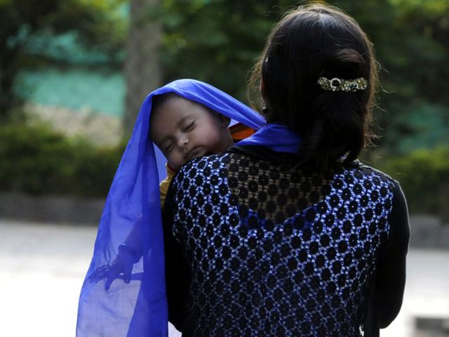 A woman protects her child from the scorching sun in Indore on Friday. (Arun Mondhe/HT photo)