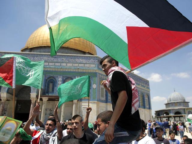 Palestinians wave national flags as they demonstrate on the Al-Aqsa mosque compound in the Old City of Jerusalem to mark the 67th anniversary of the Nakba on May 15, 2015. 'Nakba' means in Arabic 'catastrophe' in reference to the birth of the state of Israel 67-years-ago in British-mandate Palestine, which led to the displacement of hundreds of thousands of Palestinians who either fled or were driven out of their homes during the 1948 war over Israel's creation. (AFP Photo)