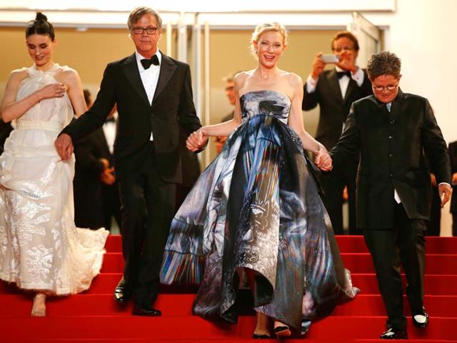 From L to R: Rooney Mara, US director Todd Haynes, Cate Blanchett and US screenwriter Phyllis Nagy leave the Festival palace after the screening of the film Carol. Cate is seen in a Giles Deacon dress. (AFP)