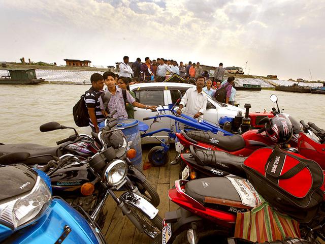 People, cars and bikes pile on ferries to cross the Brahmaputra river to reach the island of Majuli from the mainland in Assam (Photos: Raj K Raj)