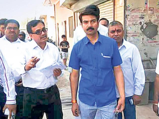 Yogender-Rai-brother-of-transport-minister-Gopal-Rai-with-municipal-officials-in-a-handout-photo-HT-couldn-t-independently-verify-the-authenticity-of-the-photo