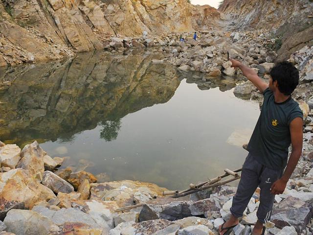 Zubed-from-Kharak-village-shows-how-a-50-feet-deep-lake-in-Raisina-has-dried-up-within-the-past-six-months-since-it-was-turned-into-a-mining-site-in-Gurgaon-on-May-21-2015-Photo-by-Parveen-Kumar-HT
