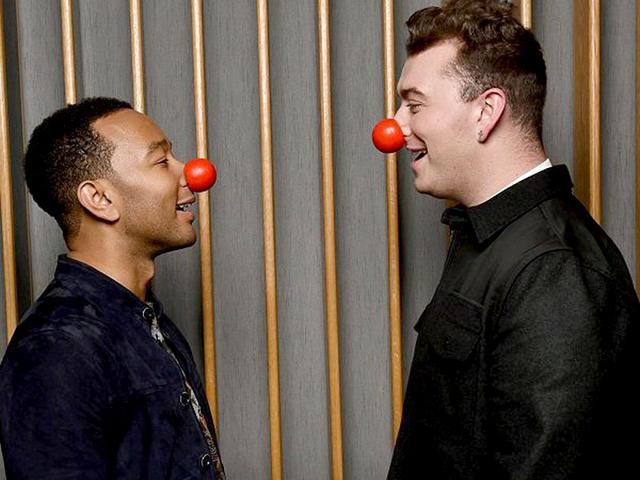 John Legend and Sam Smith wear red clown noses as part of an effort to bring attention to Red Nose Day, which started in Britain in 1988 to raise money for poverty-stricken children in the UK and Africa. This year, the fund-raiser has extended to the United States. (Twitter) John Legend and Sam Smith wear red clown noses as part of an effort to bring attention to Red Nose Day, which started in Britain in 1988 to raise money for poverty-stricken children in the UK and Africa. This year, the fund-raiser has extended to the United States. (Twitter)